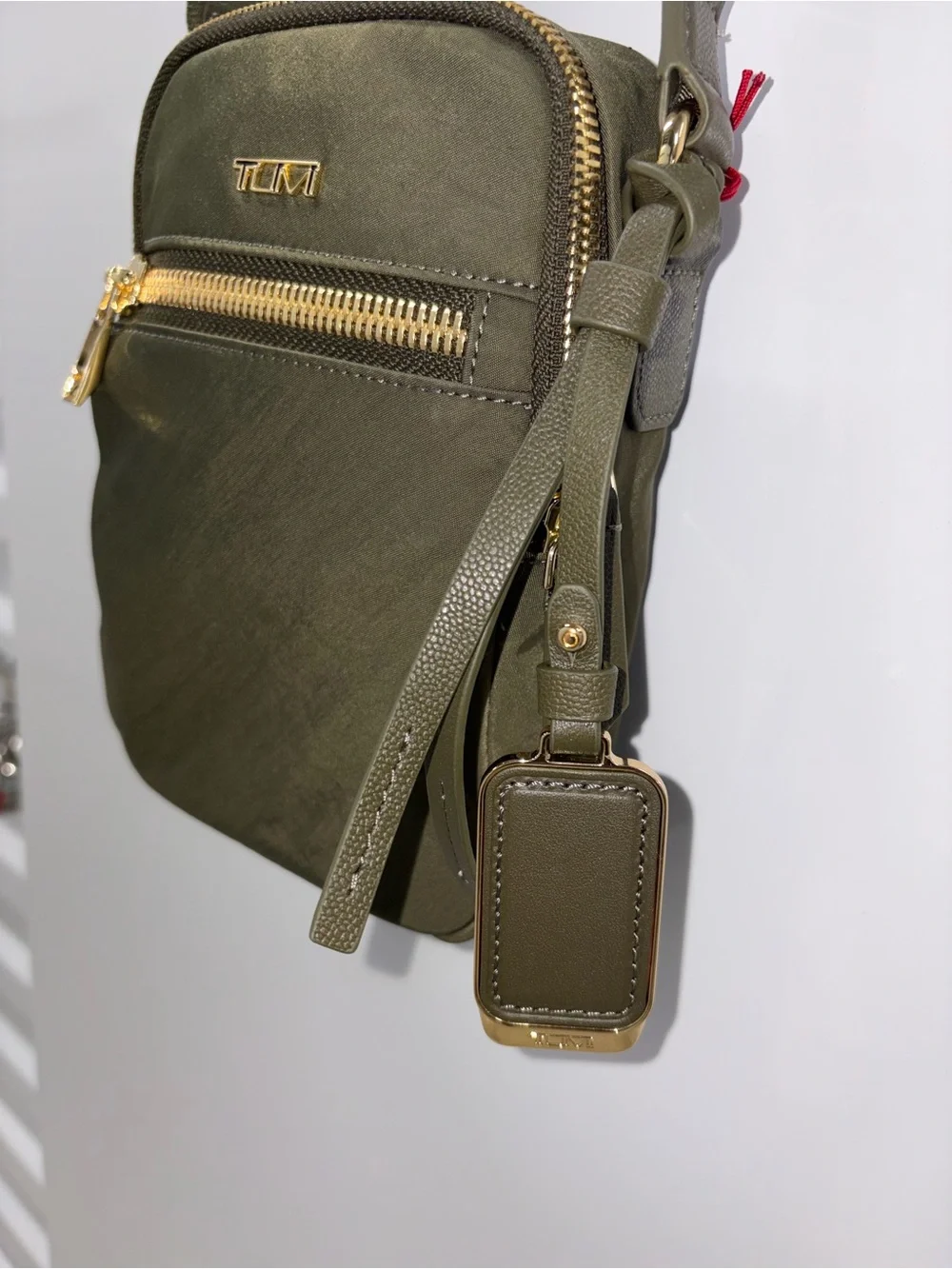 Tumi VOYAGER Olive Green Compact Crossbody with Gold Hardware